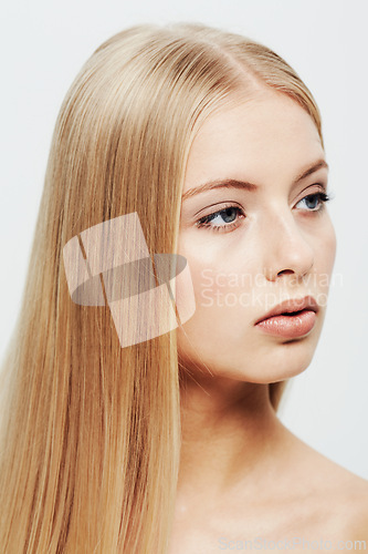 Image of Young, model and beauty or cosmetic in studio, confident and cosmetology for facial skin treatment in wellness. Woman, glow or shine in self care or blonde hair or organic makeup by white background