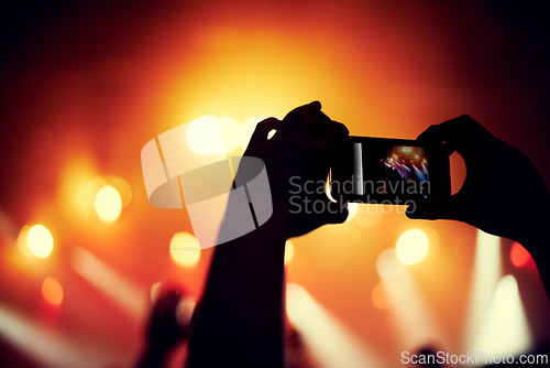 Image of Hands, smartphone or image of band at concert, music event or audience with light in bokeh. Person, photography or picture on cellphone, technology or celebration with crowd at disco performance