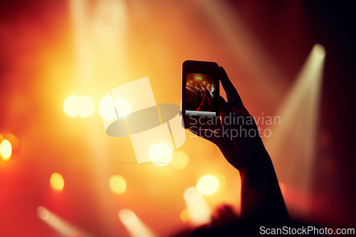 Image of Hands, smartphone or image of performance at concert, music event or audience with flashlight in bokeh. Person, photography or online on cellphone, technology or celebration with crowd for live band