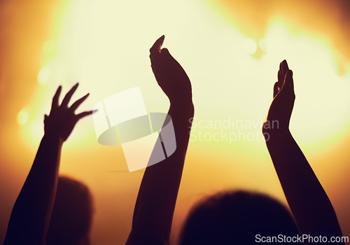 Image of Concert, applause and hands of people in audience or crowd with energy for dance party at night. Music, light and event with group of fans at rock performance on stage for celebration festival