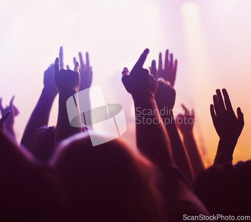 Image of Rock concert, hands and music festival with people, energy and party with fun and entertainment. Freedom, dance or crowd screaming with excitement and social with audience or group with celebration