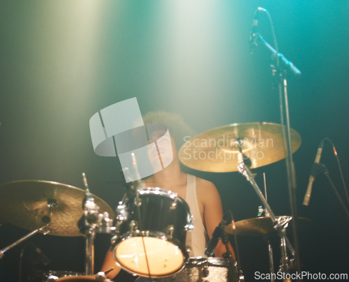 Image of Man, drums and playing at concert in band for performance, show or party event at night. Male person, drummer or performer musician on base instrument for rock festival, audience or crowd of fans