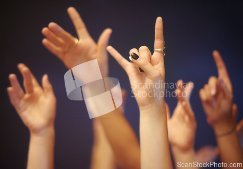 Image of Rock on gesture, hands and music festival with people, celebration and party with entertainment and night. Concert, energy and crowd with symbol and excited with audience and group with performance