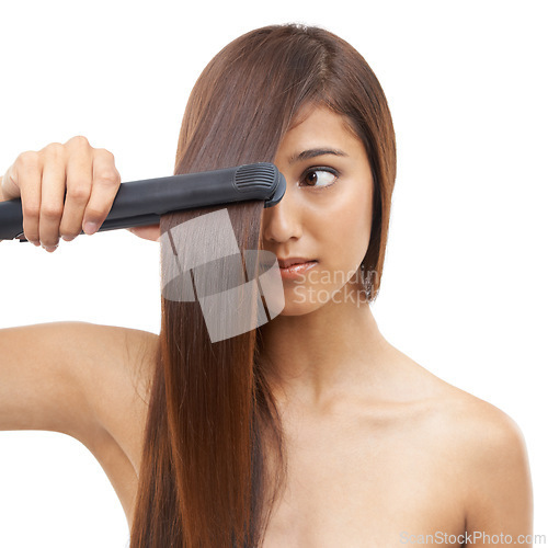 Image of Beauty, straightener and young woman in studio for cosmetic, salon and hair care treatment. Flat iron tool, heat and confident female person with healthy hairstyle routine by white background.