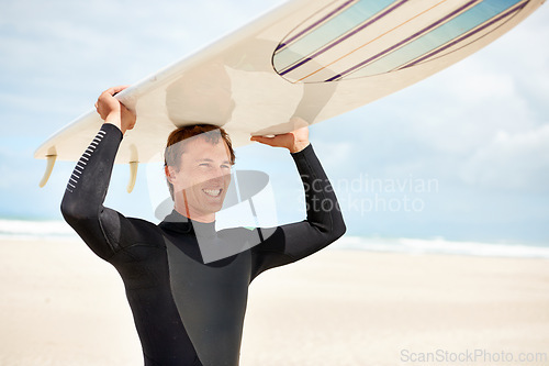 Image of Surfer, man and smile with surfboard, beach for waves and sea with travel, extreme sports and happy athlete outdoor. Fitness, wellness and summer on nature for surfing on tropical island in Australia