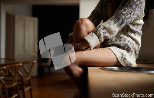 Image of Woman, hands and waiting on kitchen counter in mental health, patience or lonely morning at home. Legs of female person in relax on table by sink or basin in stress, anxiety or depression at house