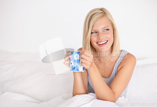 Image of Woman, relax and thinking in bed with coffee in morning or planning ideas for future with drink. Healthy, person and girl in bedroom with tea on holiday, vacation or wellness from rest in apartment