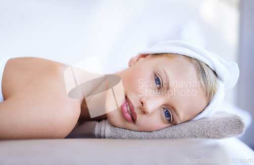 Image of Portrait, woman and relax on table in spa for skincare, beauty and luxury treatment for wellness. People, rest and face of calm person on bed in hotel for massage or dermatology care for body