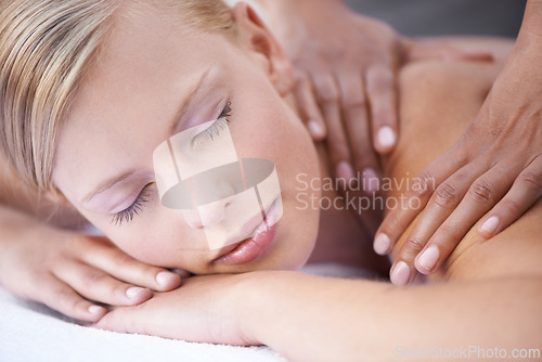 Image of Young woman, hands and massage for back in spa, health and wellness on bed for physical therapy. Person, reflexology and masseuse for body treatment by touch and muscle comfort with peace at resort