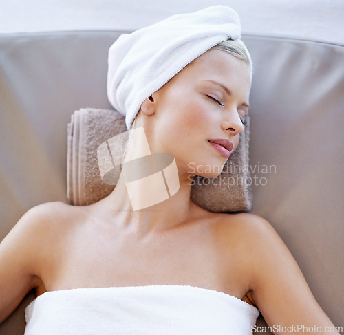 Image of Young woman, relax and rest in spa for wellness, beauty and peace with body treatment in salon. Person, sleeping or zen on massage bed at luxury resort, detox or comfort for stress free on holiday