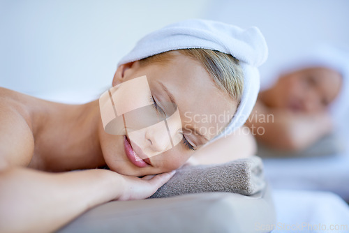 Image of Woman, relax and lying on table in spa with peace for skincare, beauty and luxury treatment for wellness. People, rest and face of calm person on bed in hotel for massage or dermatology care for body