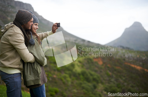 Image of Couple, hiking selfie and mountains for travel, journey and adventure with photography and mock up space. Happy people with love, hug and profile picture for trekking in winter and nature tourism