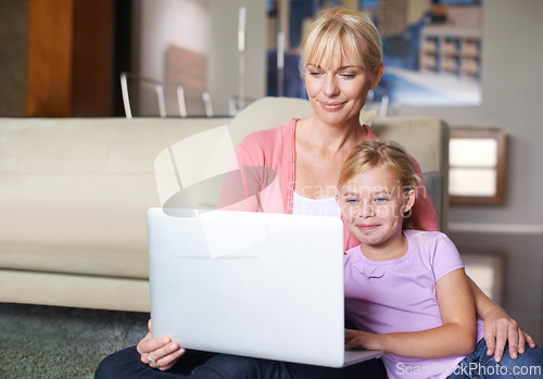 Image of Mother, child and relax by laptop on living room floor, happy and stream subscription in apartment. Daughter, woman and smile on computer by online cartoon, technology and connected on couch in house