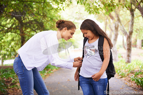 Image of Parent, helping and student with backpack in park, care and support in education development in city. Mother, child and happy on campus outdoor for love and tying bag for learning in middle school