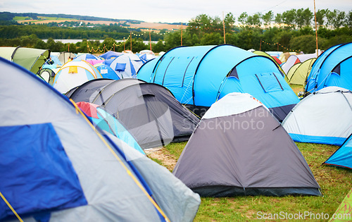 Image of Tents, field and music festival outdoor for camp event in forest for party celebration, rave weekend on vacation. Shelter, land for crowd concert or dj disco accommodation, park trip in woods nature