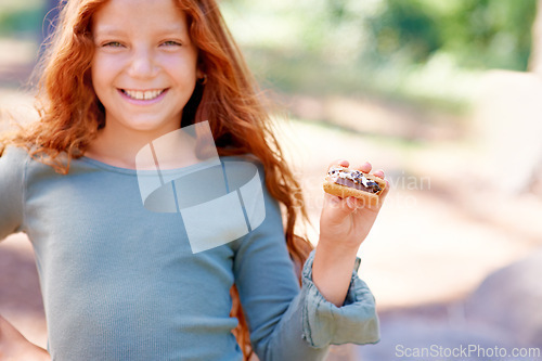 Image of Happy, child and portrait of eating smores outdoor, camping and relax at barbecue with dessert or cookie. Girl, smile and hungry for biscuit with marshmallow in woods or forest on holiday or vacation