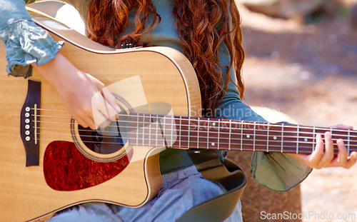 Image of Nature, camp and closeup of girl with guitar for entertainment, talent or music in woods or forest. Playing, musician and child with acoustic string instrument outdoor in park on weekend trip.