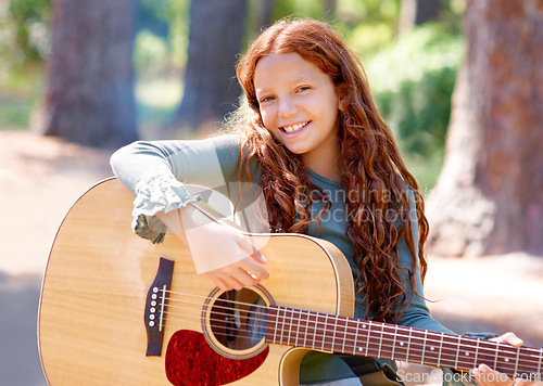 Image of Camp, portrait and girl child with guitar for entertainment, talent or music in woods or forest. Nature, musician and kid with acoustic string instrument outdoor in park or field on weekend trip.