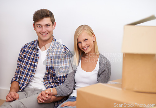 Image of Couple, moving and new home, portrait with boxes for packing and real estate, happy holding hands and support. Property, investment and people smile with cardboard for relocation, mortgage or rent