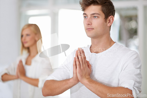 Image of Prayer hands, meditation and people in a studio with peace, zen and mental health, wellness or balance. Mindfulness, relax and team with holistic, breathing or energy exercise for spiritual awareness