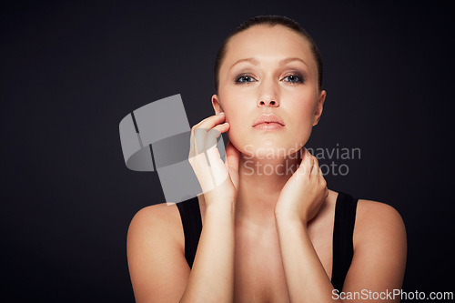 Image of Makeup, beauty and hands on face of woman in studio for cosmetology, shine or wellness treatment on black background. Cosmetic, glowing skin and female model portrait with confidence and results