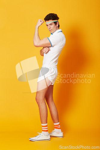 Image of Portrait, tennis and man flexing arms with fitness and workout on a yellow background. Person, model and athlete in sportswear and training with confidence and proud with wellness and healthy