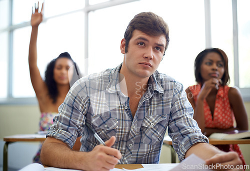 Image of Students, questions and learning in classroom for education, language development and knowledge in high school. Young people raise hands at desk for answer, quiz and test notes with information