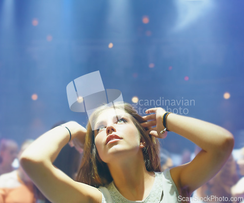 Image of Club, night and woman at party to dance to techno or dj at music festival and rave at concert event. Nightclub, girl and celebration with energy, light and relax with movement to disco on vacation