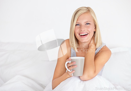 Image of Woman, portrait and drinking coffee in morning for bed relax or home beverage for comfort, peace or happy. Female person, face and smile with mug on duvet for warm caffeine or vacation, rest or tea