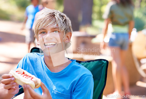 Image of Eating, hotdog and portrait of kid outdoor in camping chair and relax at barbecue with lunch. Happy, child and hungry for food from bbq in park, woods or forest on holiday or vacation in summer