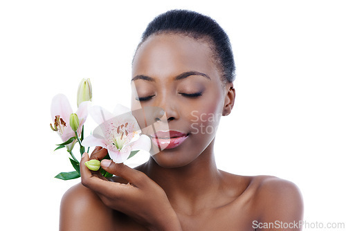 Image of Black woman, flower and natural beauty, dermatology and skincare for glow and wellness on white background. Nature, healthy skin and sustainable cosmetics, face with shine and orchid in a studio