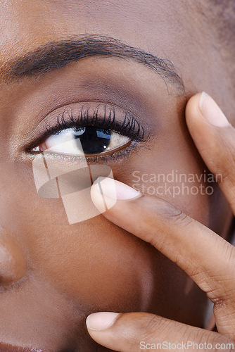 Image of Eye, closeup and black woman with beauty, vision and skincare with dermatology. Half, portrait and African model with natural makeup and nails on face with healthy skin from cosmetics or facial