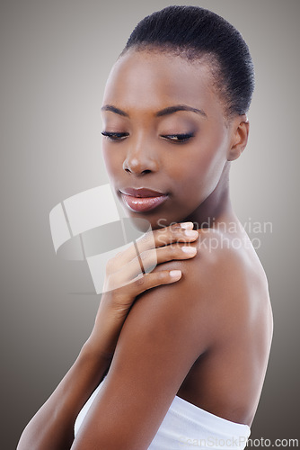 Image of Skincare, touch and face of black woman in studio with shoulder, natural makeup and healthy glow. Cosmetics, dermatology and beauty model girl on grey background for skin care, shine or wellness.