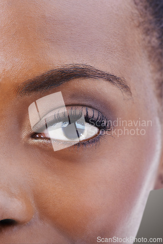 Image of Eyeshadow, makeup and black woman closeup with beauty and skincare on half of face. Eye, portrait and African model with healthy glow and shine on skin from dermatology, cosmetics or foundation