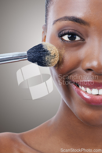 Image of Brush, makeup and black woman, portrait and beauty with foundation for cosmetics, wellness and cropped on grey background. Shine, cosmetology and tools to apply powder, glow and shimmer in studio