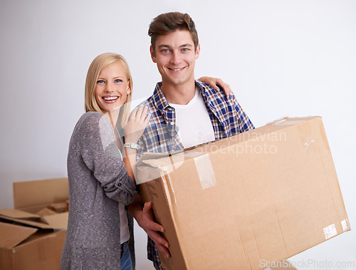 Image of Couple, moving and new house with box for packing, happy with real estate and support in portrait and smile. Property, investment and people with cardboard package for relocation, mortgage or rent