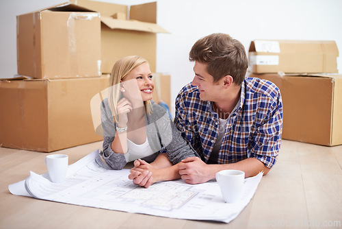 Image of Man, woman and happy with floor plan blueprints for home renovation or moving boxes, apartment or investing. Couple, ground and paper for house development for improvement, buying or new beginning