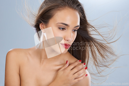 Image of Woman, face and beauty in skincare with red lipstick for makeup or cosmetics on a gray studio background. Female person or model with manicure in haircare, cosmetology or dermatology at salon or spa