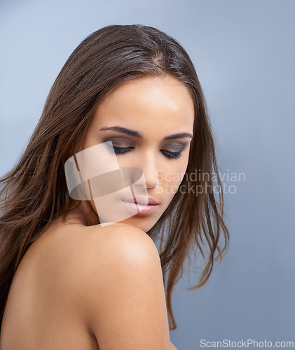 Image of Woman, hair and natural beauty in skincare or cosmetics on a blue studio background. Face of young attractive female person, brunette or model with makeup for facial treatment or haircare on mockup