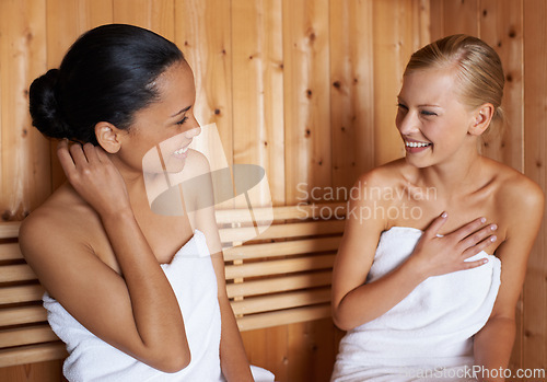 Image of Women, relax and talking in sauna at spa with healthy detox of sweat for beauty, wellness and skincare. Friends, treatment and sitting in steam room with a smile for anti aging benefits to body