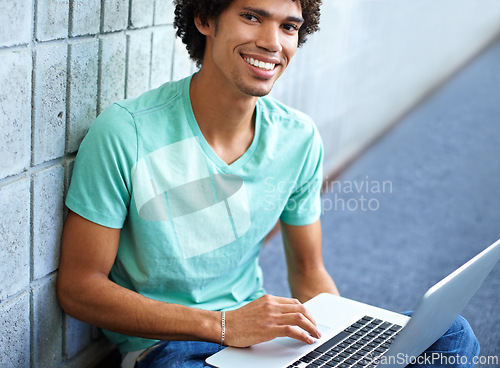 Image of Student, black man in portrait and laptop for education, e learning and typing essay, research or planning in college. Young smart person with computer for university, FAQ or online studying on floor