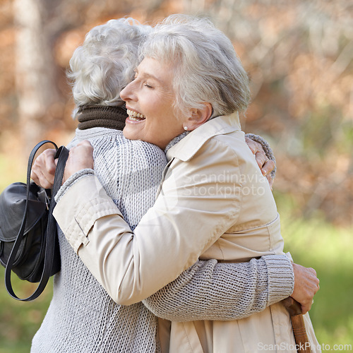 Image of Nature, happy and elderly friends hugging for support, bonding or care in outdoor park or garden. Love, smile and senior women in retirement embracing for greeting, connection or trust in field.