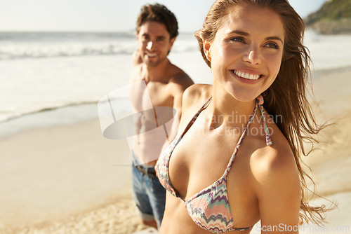 Image of Happy, travel and couple walking at a beach with love, adventure and bonding in nature together. Care, smile and people at the sea for summer, date and romantic journey while exploring Miami ocean