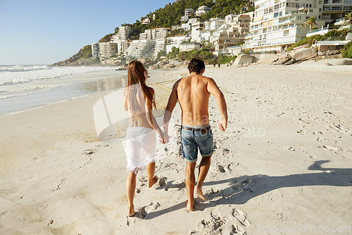 Image of Running, back and couple holding hands at a beach with bonding, energy and having fun in nature together. Summer, love and people at the ocean for adventure, travel and journey, explore or sea date