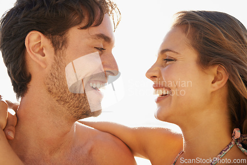 Image of Beach, love and happy couple hug outdoor with support, trust and care while bonding in nature together. Face, smile and people with gratitude, fun or enjoying relationship, moment or romance