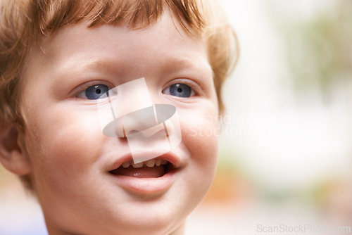 Image of Toddler, outdoor and face of happy kid in garden, nature or park for fun freedom or playing in backyard. Blur, excited boy and curious male baby outside for child development, smile or growth alone