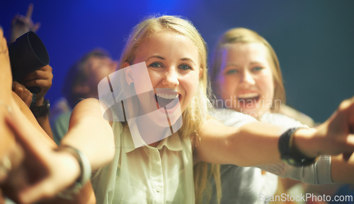 Image of Friends, happy or selfie at concert in portrait, bonding or excited for social fun at music festival. Women, together or smile on face at live show, event or celebration in crowd at disco performance