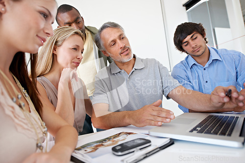 Image of Men, women and laptop in meeting for creative collaboration at magazine agency for problem solving, project or proposal. Group, diversity and brainstorming for company ideas, campaign or planning