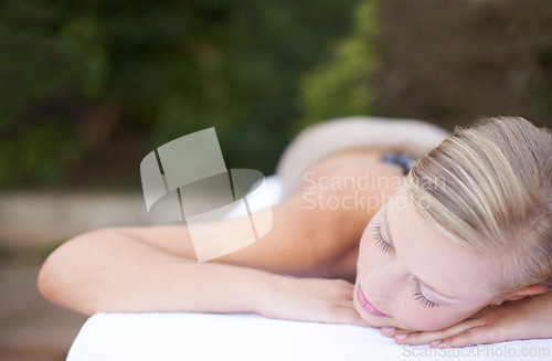 Image of Luxury, woman and sleeping on massage bed with comfort for wellness, mock up and beauty treatment or body care. Person, relax or physical therapy at resort, salon table and spa on holiday or vacation