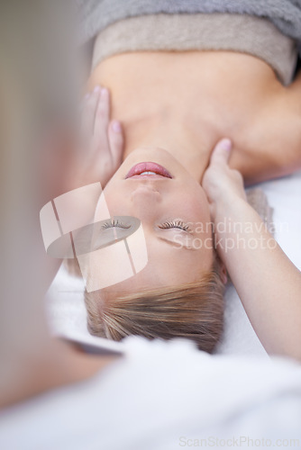 Image of Young woman, relax and massage in spa for health, wellness and peace with hands for shoulder pain. Person, comfort or release of muscle tension by masseuse, body treatment or detox in resort for zen